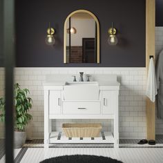 a white sink sitting under a mirror in a bathroom