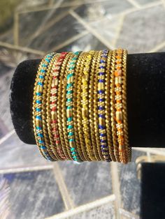 Add a touch of glamour to your special occasion with this beautiful multicoloured metal and thread work bangle set from My Jewel Box. The exquisite piece features natural stones and excellent cut grade that will surely catch everyone's attention. Perfect for engagement, wedding, anniversary, birthday, and Valentine's Day celebrations, this Indian/Pakistani bridalwear partywear jewellery is a great addition to your collection. The set is made of high-quality alloy material that guarantees durabil Adjustable Multicolor Bracelets For Navratri, Adjustable Multicolor Navratri Bracelets, Bohemian Multicolor Beaded Bracelets For Weddings, Festive Fusion Style Metal Bangle, Adjustable Multicolor Cutdana Bracelets, Multicolor Bracelets For Navratri Celebration, Multicolor Bohemian Beaded Bracelets For Festive Occasions, Adjustable Multicolor Bracelets For Diwali, Multicolor Bohemian Beaded Bracelet For Festive Occasions