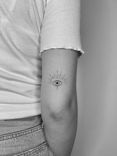 a woman's arm with an all seeing eye tattoo on the left inner arm