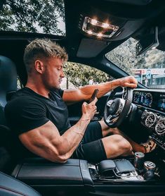 a man sitting in the driver's seat of a car