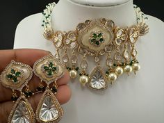 This is a Statement jewelry piece This is a gorgeous modern White and green Premium quality fusion in HQ Tyaani kundan, natural stones and small pearls beads, statement choker necklace set with matching earrings is very unique in itself. This is a modern style chic/choker set which also suits as bridal necklace. This is so beautiful to look at and a perfect one for Weddings and party wear. Color : gold, green, white Necklace length :  (choker necklace length) Earring length : 1.9 inch Earring wi Green Fusion Kundan Necklace For Reception, Green Fusion Style Kundan Necklace For Reception, Green Fusion Kundan Necklace For Weddings, Fusion Kundan Wedding Choker, Elegant Green Choker For Reception, Elegant Green Choker With Stone Work, Green Kundan Choker Necklace For Wedding, Bridal Necklace Set, Stone Choker