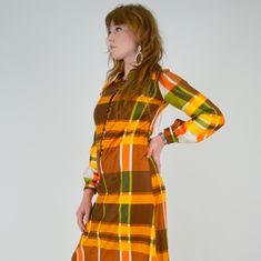 "Stunning 1970's plaid maxi dress! Made in a bold Autumn toned plaid pattern. Made in a super soft cotton material. The cotton has a pretty sheen to it, much like a polished cotton. Pointed collar, button down bodice / collar. Balloon sleeves with buttons at cuffs. Unlined. ♥♥ Fits Like: XS - Small TAG: -- BRAND: -- Excellent Vintage Condition: ♥ MEASUREMENTS; Bust: 33\" Waist: 31\" Hips: 40\" Length: 54.5\" Shoulder seam to seam: 14\" Underarm seam: 18.5\" Measurements of Model: Bust: 35\" Wais Fitted Retro Plaid Dress For Fall, Retro Plaid Mini Dress, Retro Fitted Maxi Dress For Fall, Retro Maxi Dress For Fall, Plaid Maxi Dress, Of Model, Vintage Store, May 23, Balloon Sleeves