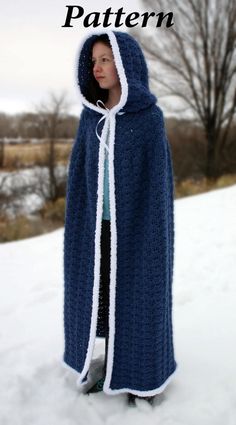 a woman wearing a blue crocheted hooded blanket in the snow