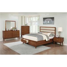 a bedroom scene with focus on the bed and dressers, mirror and nightstand set