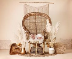 a baby sleeping in a wicker chair surrounded by feathers and other things on the floor