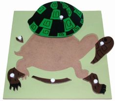 a paper cut out of a turtle with a hat on