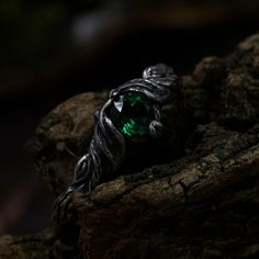 a green ring sitting on top of a rock