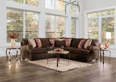 a living room filled with furniture and large windows