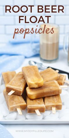 homemade rootbeer float popsicles on a plate with a glass of milk in the background