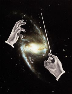 two hands holding a stick in front of a spiral galaxy