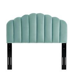 an upholstered headboard with black metal legs and a blue velvet fabric cover