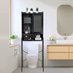 a white toilet sitting next to a wooden cabinet in a bathroom under a large mirror