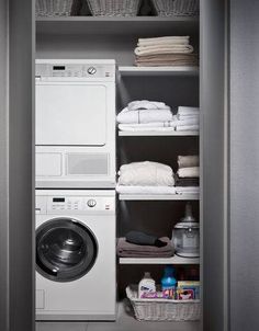 a washer and dryer are in the closet next to each other on shelves