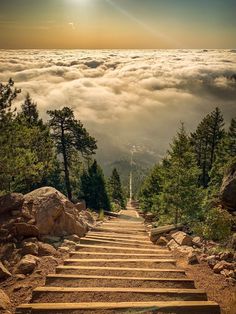 there are many steps that lead up to the top of this mountain in the clouds