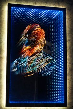 a painting is shown on the wall in front of a blue light with an image of a man's head