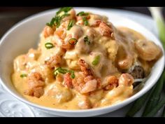 a white bowl filled with food on top of a table