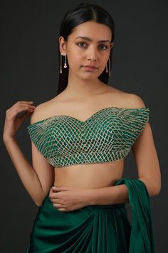 Emerald green pre-draped saree with pleated detailing. Paired with sequin, bead embroidered padded blouse.
Components: 2
Pattern: Embroidery
Type Of Work: Sequin, bead
Neckline: Sweetheart neck
Sleeve Type: Off shoulder sleeves
Fabric: Satin, Net
Color: Emerald Green
Other Details: 
Criss cross back
Attached lining
Approx. product weight: 1 kgs
Model height: 5ft 7inches, wearing size S
Occasion: Destination Wedding - Aza Fashions Green Saree Blouse For Reception, Elegant Draped Green Lehenga, Green Traditional Draped Wedding Blouse, Elegant Green Top For Wedding, Green Georgette Party Tops, Green Bollywood Georgette Tops, Green Georgette Choli For Evening, Festive Green Georgette Top, Traditional Green Choli For Evening