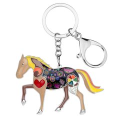 a keychain with a horse painted on it's side and hearts in the back