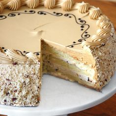 a cake that has been cut into pieces and is sitting on a white platter