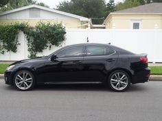 a black car parked in front of a house