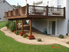 a wooden deck on the side of a house