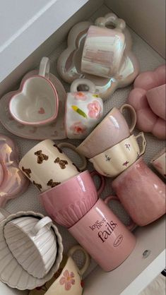 a drawer filled with lots of cups and saucers