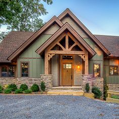 a large house with stone and wood trimmings on the front door, windows, and entry way