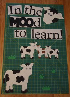 there is a sign that says in the mood to learn with some cows on it