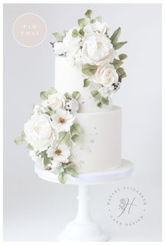 two tiered wedding cake with white flowers on top