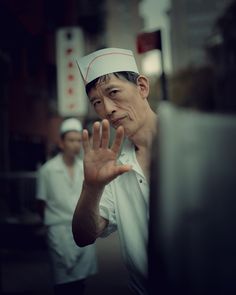 a man wearing a chef's hat making a hand gesture