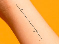 a small tattoo on the wrist that reads, love is in the air and has an arrow