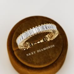 a diamond ring sitting on top of a wooden box