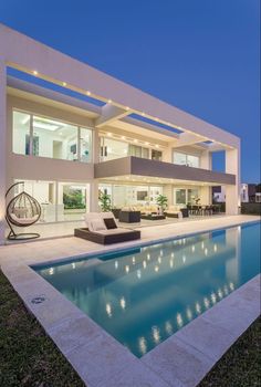 a house with a swimming pool in front of it