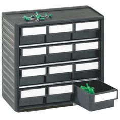 a black and white drawer with drawers on the bottom, two green plastic containers in front of it