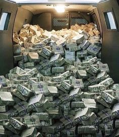 the back of a van filled with stacks of cash sitting on top of each other