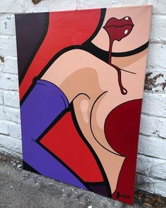 a painting of a woman's breast on a brick wall