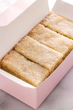 three pieces of cake in a pink box