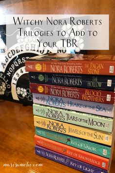 a stack of books sitting on top of a wooden table