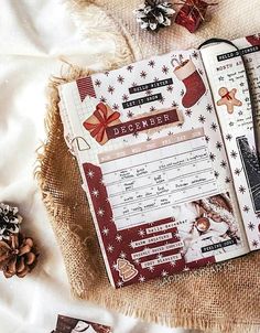 an open christmas planner sitting on top of a table next to other items and decorations