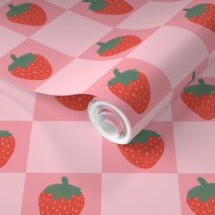 a wallpaper with strawberries on pink checkered paper and green leafy design