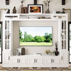 a large white entertainment center with shelves and vases