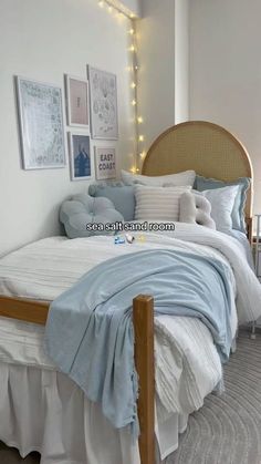 a bed with white sheets and blue blankets