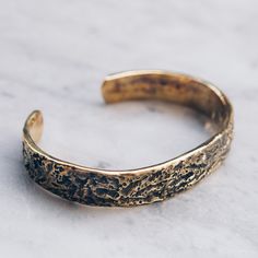 Brass Abstract Band Bracelet that is slightly adjustable. Available in women's and men's lengths. A rustic gold cuff bracelet style adds the perfect touch dressed up or down. Bracelet Size Medium (Women's) Large (Men's) Available in 925 Sterling Silver https://etsy.me/3i4Htje A note about brass jewelry and oxidization: Verdigris is the common name for a green coloring obtained through the application of acetic acid to copper plates or the natural patina formed when copper, brass or bronze is wea Adjustable Gold Engraved Wristband, Adjustable Engraved Gold Wristband, Adjustable Hammered Bronze Bracelets, Adjustable Rustic Bronze Bracelets, Rustic Adjustable Bronze Bracelets, Rustic Adjustable Bronze Bracelet, Adjustable Gold Band Cuff Bracelet, Rustic Gold Bracelets As Gift, Rustic Gold Bracelets For Gifts