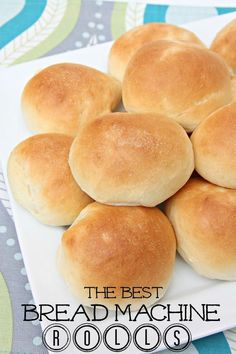 a white plate topped with bread rolls on top of a blue and green table cloth