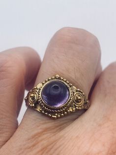 Deep purple amethyst stone  Lovely vintage golden bronze setting Size 7.5  Our jeweler can custom re size this for a $20 fee.  All rings are shipped in a nice gift box.   Check out our over a THOUSAND great reviews Engraving is $4 per letter and is not always perfect depending on the piece. It can take a few days if the jeweler is busy. This is payable to Paypal Judithsltd@gmail.com Vintage Amethyst Ring Gold, Gold Spiritual Rings With Bezel Setting, Spiritual Gold Rings With Bezel Setting, Vintage Yellow Gold Amethyst Ring, Gold Crystal Ring With Bezel Setting As Gift, Heirloom Style Purple Amethyst Collectible Ring, Heirloom Purple Amethyst Collectible Ring, Vintage Gold Amethyst Rings, Antique Crystal Ring As Gift