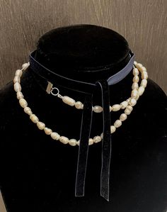 Unique natural pearl bead necklace with navy velvet ribbon. Can be worn long as a single strand of pearls or double wrapped around the neck. If you have a length preference please message me. When double wrapped the pearls fit closer to a choker necklace style. Adjustable Pearl Embellished Choker Necklace, Adjustable Pearl Choker For Formal Occasions, Adjustable Pearl Charm Necklace For Formal Occasions, Adjustable Multi-strand Pearl Necklace For Party, Formal Adjustable Pearl Chain Beaded Necklace, Adjustable Multi-strand Pearl Necklace, Formal Adjustable Beaded Pearl Necklace, Pearl Bead Necklace, Velvet Necklace