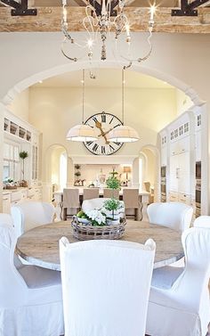 a dining room table with chairs and a chandelier