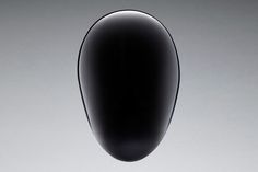 a black vase is floating in the air