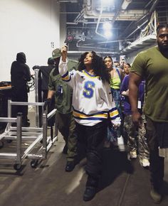 a group of people standing around each other in a building with one person taking a selfie