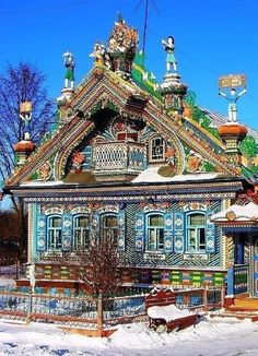 a colorfully painted house sits in the snow